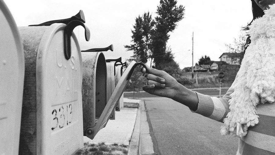 Mail being collected from a roadside mailbox