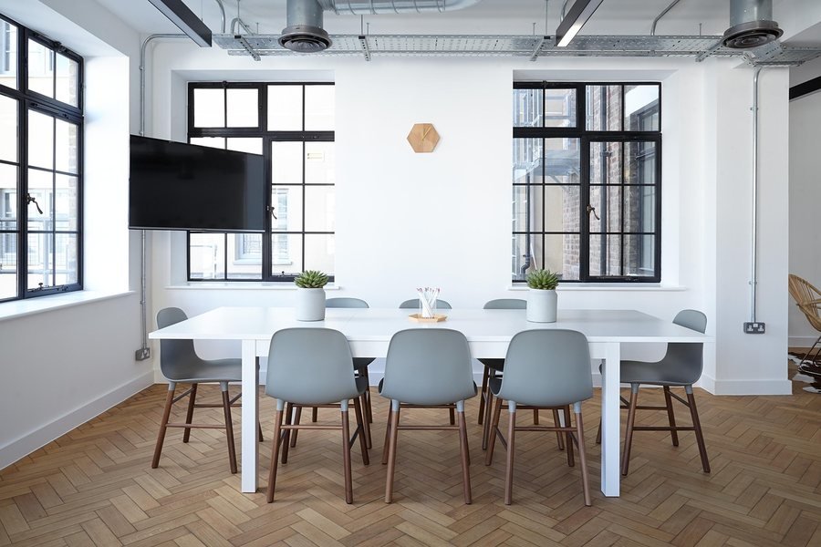 An empty boardroom table set for a meeting