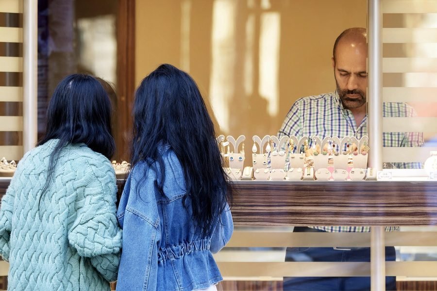Customers at the counter of a small shop