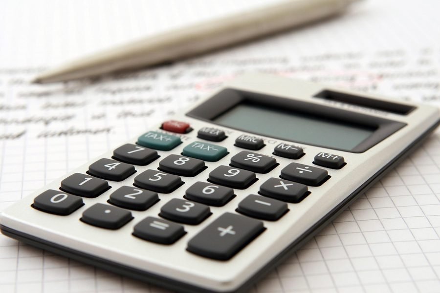 A payroll summary beside a calculator