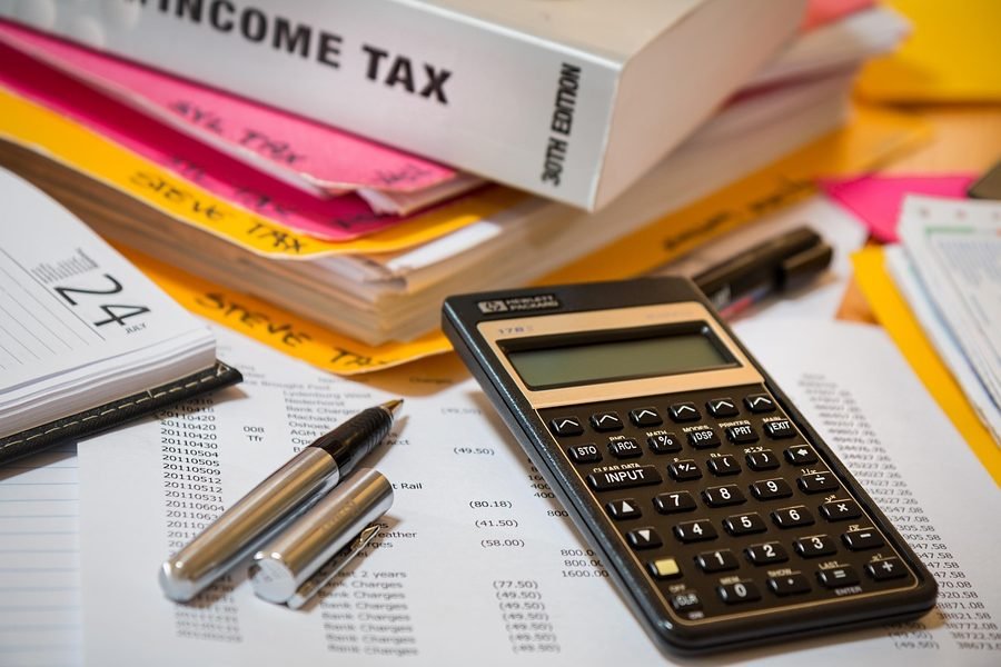 Tax paperwork spread out beside a calculator